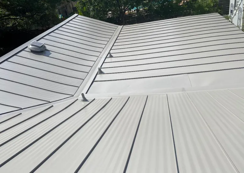 Solar attic fan installed on a metal roof for Roof Ventilation in Cheltenham
